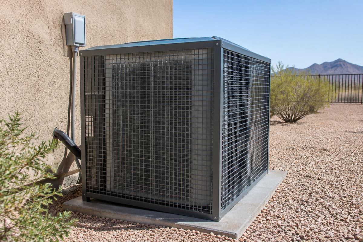 Representative photo: a metal hail guard installed over an outdoor air conditioning condenser unit